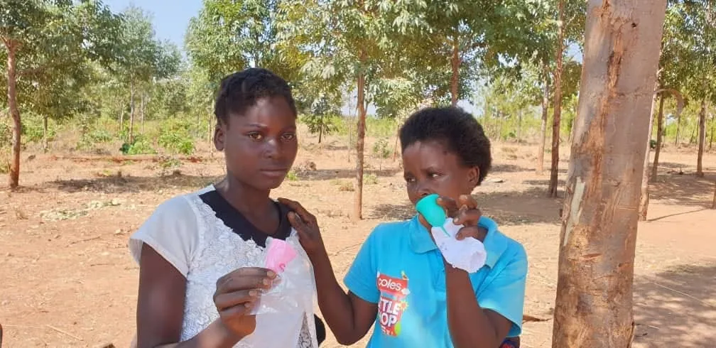 Community campaign beneficiaries holding Chic Cup products