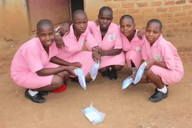 Girls receiving menstrual care products through 1Cup Foundation outreach